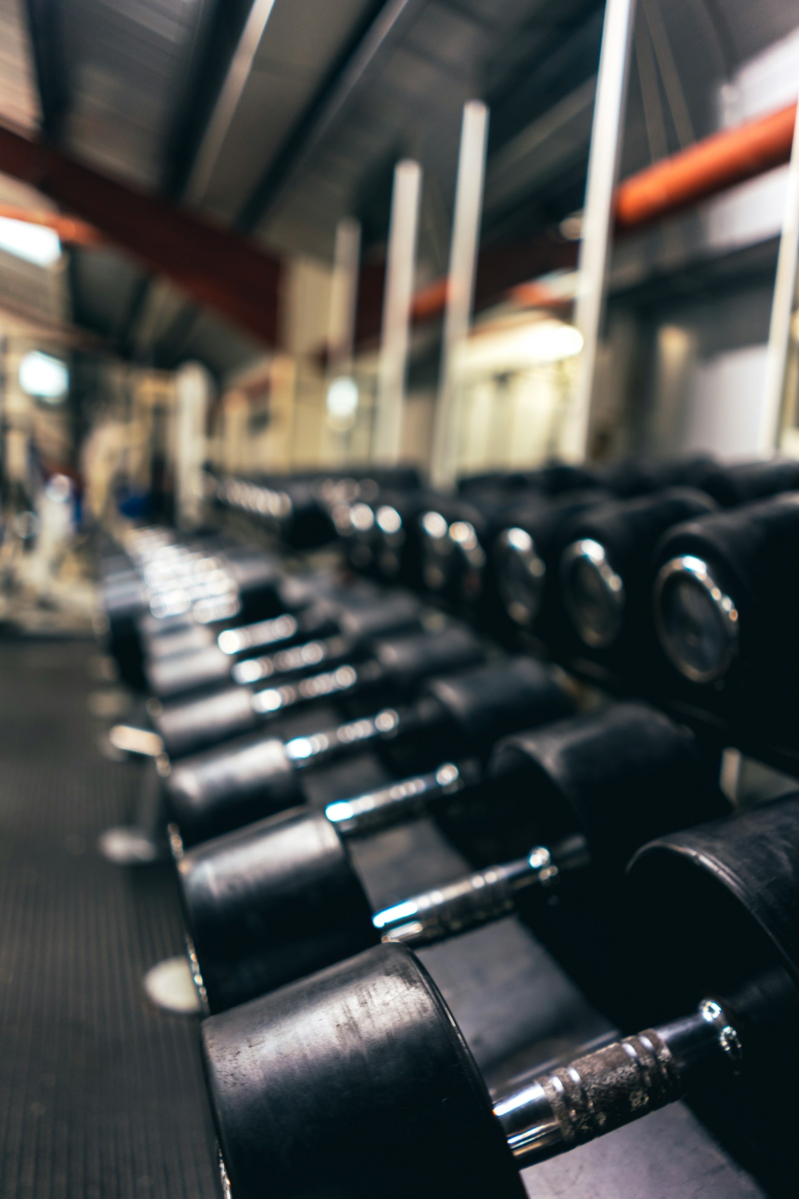 Loaded barbell plates stacked on a bar in a gym